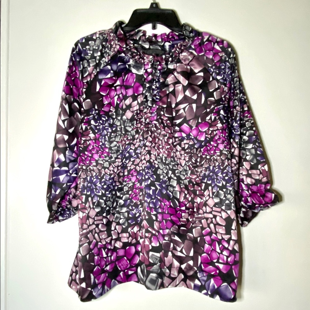 Ninety shirt with a wild print. Different shades of pinks, purples, & grays